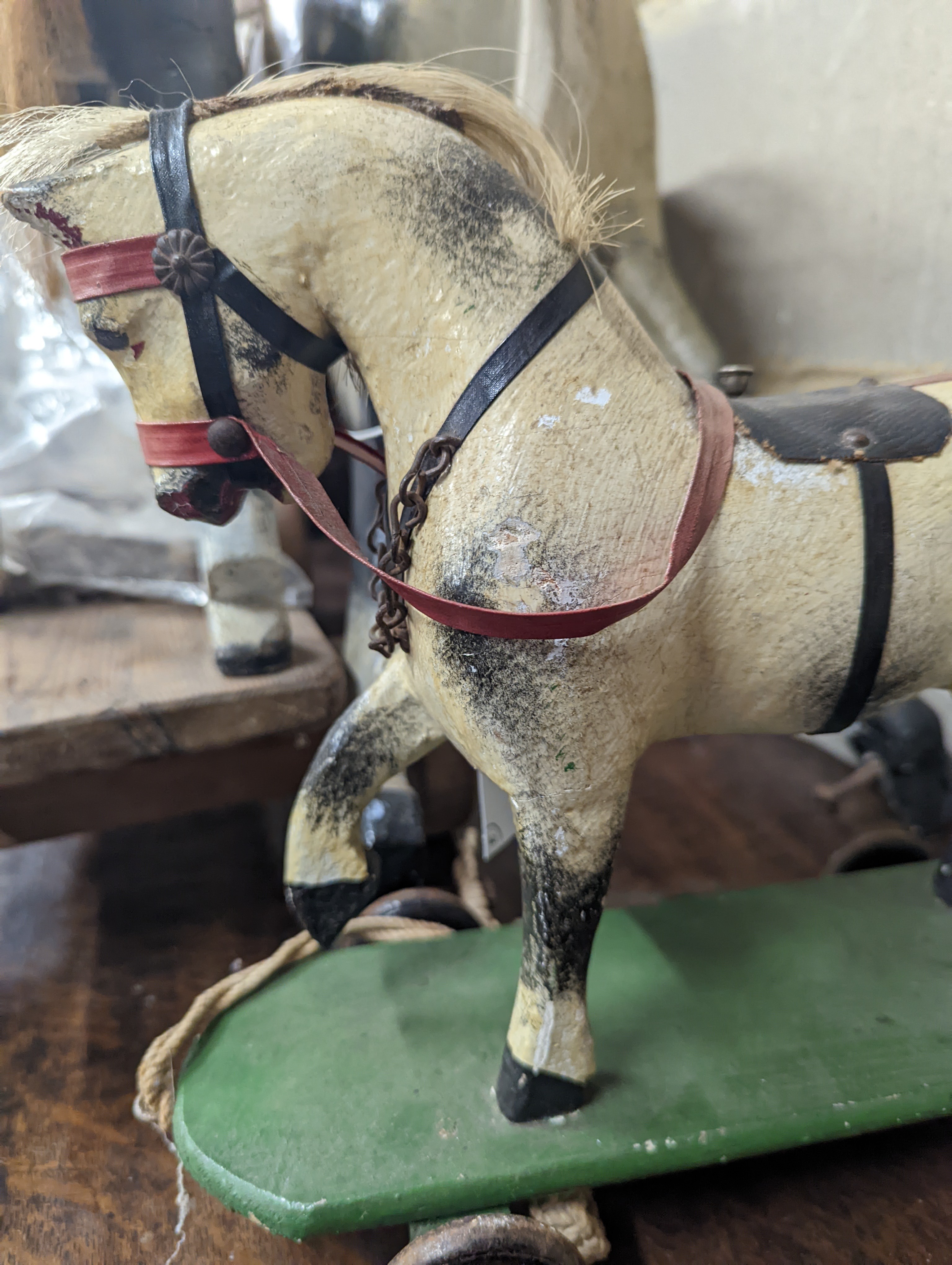 A Victorian carved and painted wood rocking horse, lacking underframe, length 77cm and two painted wood hobby horses, 58cm and 38cm